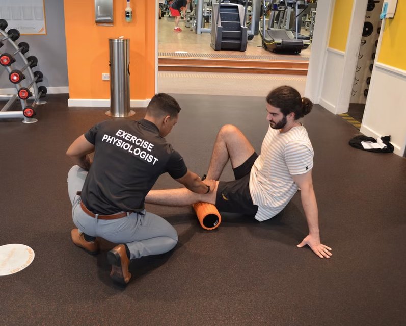 Practitioner assisting client with resistance band